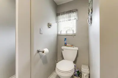 a small bathroom with a toilet and a window at Hike and Explore Western Mass Peaceful Studio in Palmer