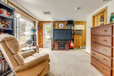 a living room with a couch and a television at Hike and Explore Western Mass Peaceful Studio in Palmer