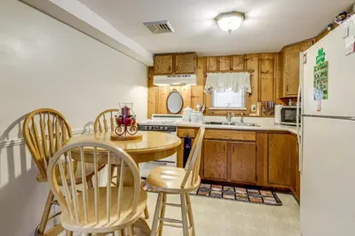 a kitchen with a table and chairs and a refrigerator at Hike and Explore Western Mass Peaceful Studio in Palmer