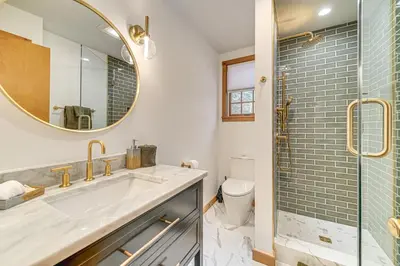 a bathroom with a sink and a shower at 8 Mi to Mt Snow Cozy Bear Cabin with Hot Tub! in Wilmington