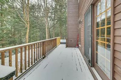 a wooden walkway leading to a porch on a house at 8 Mi to Mt Snow Cozy Bear Cabin with Hot Tub! in Wilmington