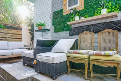 a patio with two wicker chairs and a table at Upper Clinton Hill Studio! Walk to Eats and Shops in Newark