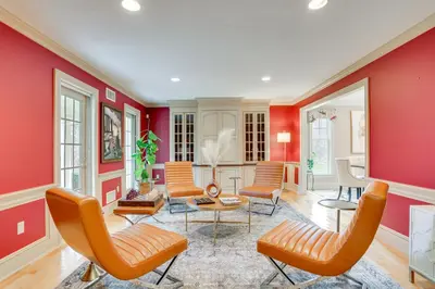 a living room with red walls and orange chairs at Pond and Gazebo Expansive Hudson Valley Escape! in Goshen