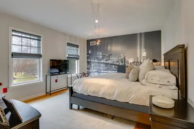 a bedroom with a large bed and a television at Pond and Gazebo Expansive Hudson Valley Escape! in Goshen
