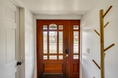 a hallway with a wooden door and a window at Walk to Athens Riverfront Park! Modern-Retro Apt in Athens