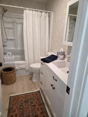 a white bathroom with a toilet and a sink at Perch, for work or wandering the Litchfield Hills in Southbury