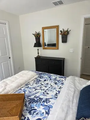 a bedroom with a bed with a mirror and a dresser at Perch, for work or wandering the Litchfield Hills in Southbury