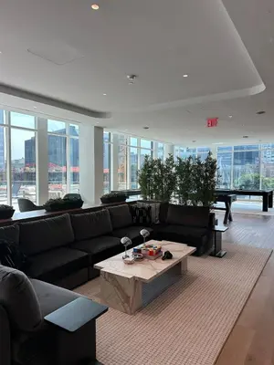 a living room with a couch and a coffee table at Bright, Modern Studio in White Plans in White Plains