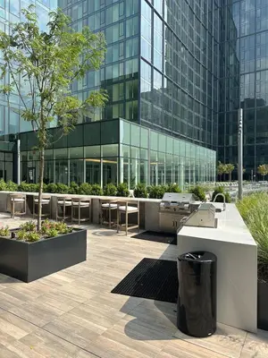 a building with a table and chairs in front of it at Bright, Modern Studio in White Plans in White Plains