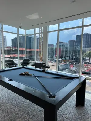 a pool table in a room with a large window at Bright, Modern Studio in White Plans in White Plains
