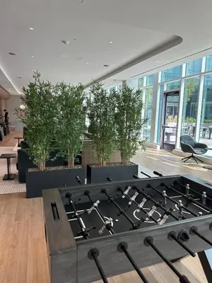 a large room with potted plants and a table at Bright, Modern Studio in White Plans in White Plains