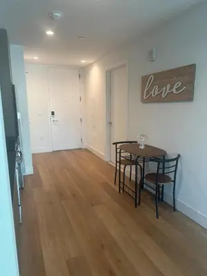 a dining room with a table and chairs in a room at Bright, Modern Studio in White Plans in White Plains