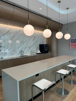 a kitchen with a counter and two stools at Bright, Modern Studio in White Plans in White Plains