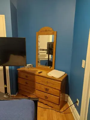 a dresser with a mirror on top of it at Grove#5 in Irvington