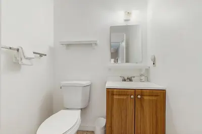 a bathroom with a toilet and a sink and a mirror at Equipe Sport 2E in Dover