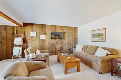 a living room with a couch and a table at Equipe Sport 2E in Dover