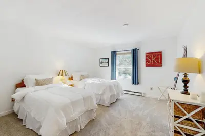 two beds in a white room with a window at Equipe Sport 2E in Dover