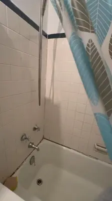 a bathroom with a shower with a toilet and a sink at Holiday Glow Apartments in Rego Park