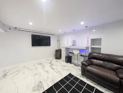 a living room with a couch and a television on a wall at Home in Mount Pocono - Sauna & Lakefront in Pocono Summit
