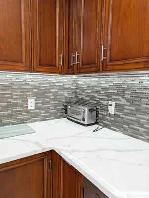 a kitchen with wooden cabinets and a microwave on the counter at Home in Mount Pocono - Sauna & Lakefront in Pocono Summit