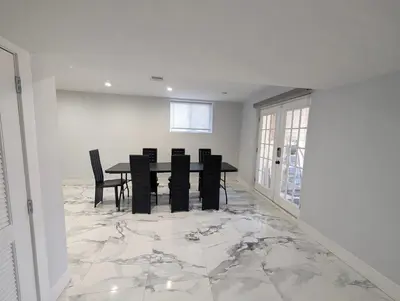 a dining room with a table and chairs on a marble floor at Home in Mount Pocono - Sauna & Lakefront in Pocono Summit
