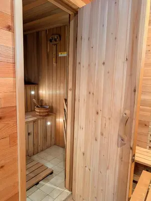 a sauna with wood paneled walls and a door at Home in Mount Pocono - Sauna & Lakefront in Pocono Summit