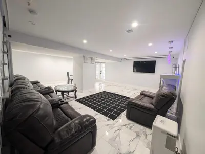 a living room with two leather couches and a tv at Home in Mount Pocono - Sauna & Lakefront in Pocono Summit