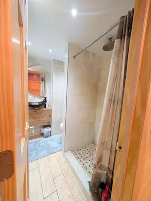 a shower with a shower curtain in a bathroom at Home in Mount Pocono - Sauna & Lakefront in Pocono Summit