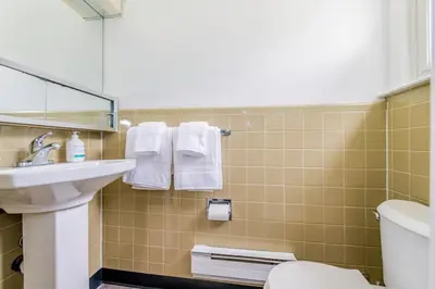 a bathroom with a sink and a toilet and towels at Catskill gem! Four bedroom on 20 quiet acres in Barryville