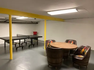 a room with two ping pong tables and chairs at Catskill gem! Four bedroom on 20 quiet acres in Barryville