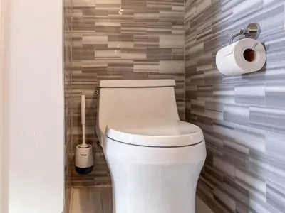 a bathroom with a toilet and two rolls of toilet paper at Suite 45 - East Harlem, Manhattan by Monthier in New York