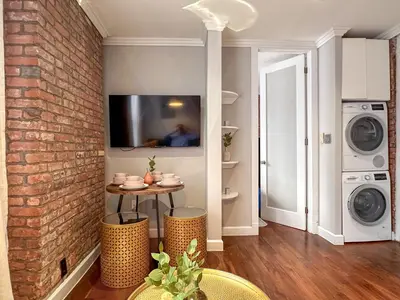 a laundry room with a washer and dryer at Suite 45 - East Harlem, Manhattan by Monthier in New York