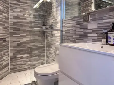 a bathroom with a toilet and a sink and a tub at Suite 45 - East Harlem, Manhattan by Monthier in New York
