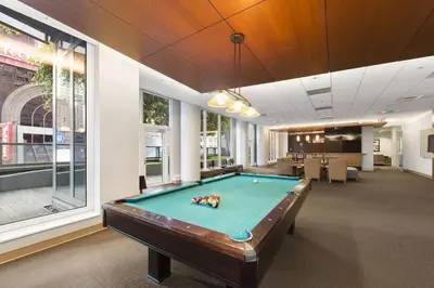 a pool table in the middle of a room at 1600 Broadway in New York