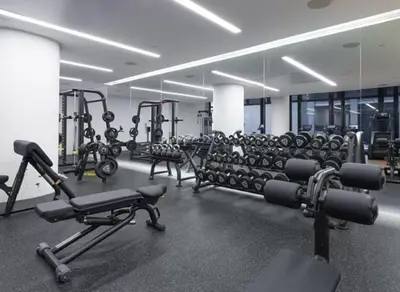 a gym with a large room with rows of exercise equipment at 685 First Ave in New York
