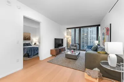 a living room with a couch and a bed at 685 First Ave in New York