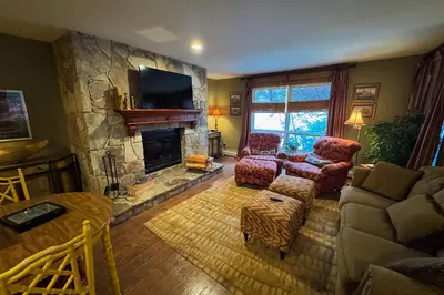 a living room with a fireplace and a couch and chairs at The Seasons P21 in West Dover