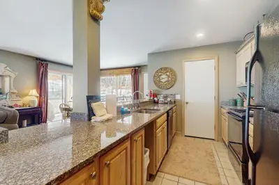 a kitchen with a large counter and a refrigerator at The Seasons P21 in West Dover