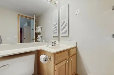 a bathroom with a sink and a mirror at The Seasons P21 in West Dover