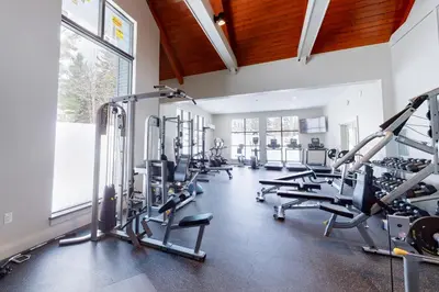 a gym with treadmills and ellipticals at The Seasons P21 in West Dover