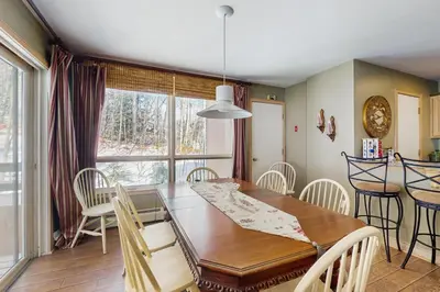 a kitchen and dining room with a wooden table and chairs at The Seasons P21 in West Dover