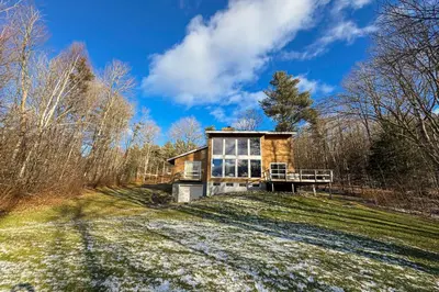 a house on top of a hill with trees at Deer Hill Retreat in Whitingham
