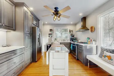 a kitchen with a ceiling fan and a kitchen island at Deer Hill Retreat in Whitingham