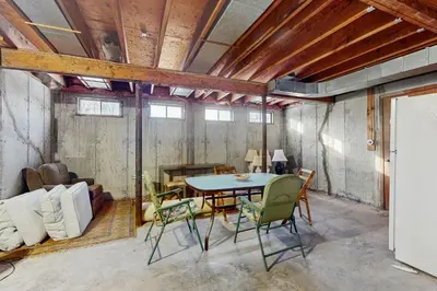 a room with a table and chairs and a couch at Deer Hill Retreat in Whitingham