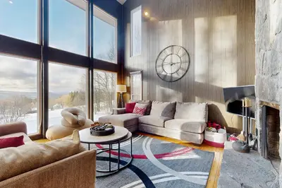 a living room with a couch and a fireplace at Deer Hill Retreat in Whitingham
