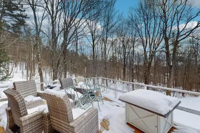 a deck with chairs and a table covered in snow at Deer Hill Retreat in Whitingham
