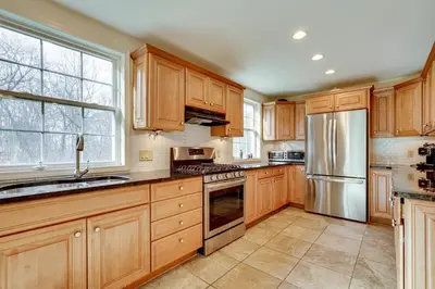 a kitchen with wooden cabinets and stainless steel appliances at 7 Mi to The Walkway Hudson Valley Adventure Base in Highland