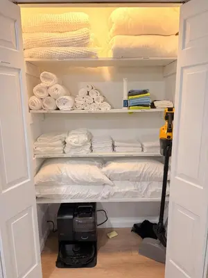 a closet filled with lots of towels and a machine at Huge Private Suite with Pool Table, Sauna & Fire Pit in Ellenville