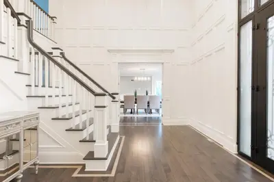 a white room with a staircase and a dining room at Luxury 4BR Magical Oasis Villa Mansion with Indoor Basketball Court and Gym in Melville