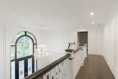 a white hallway with a staircase and a window at Luxury 4BR Magical Oasis Villa Mansion with Indoor Basketball Court and Gym in Melville